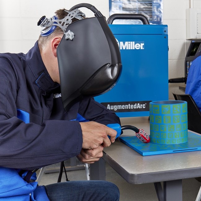 Man using the Miller AugmentedArc Augmented Reality Welding System in a training program
