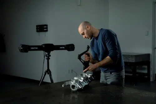 A man using a Handyprobe 3D scanner.