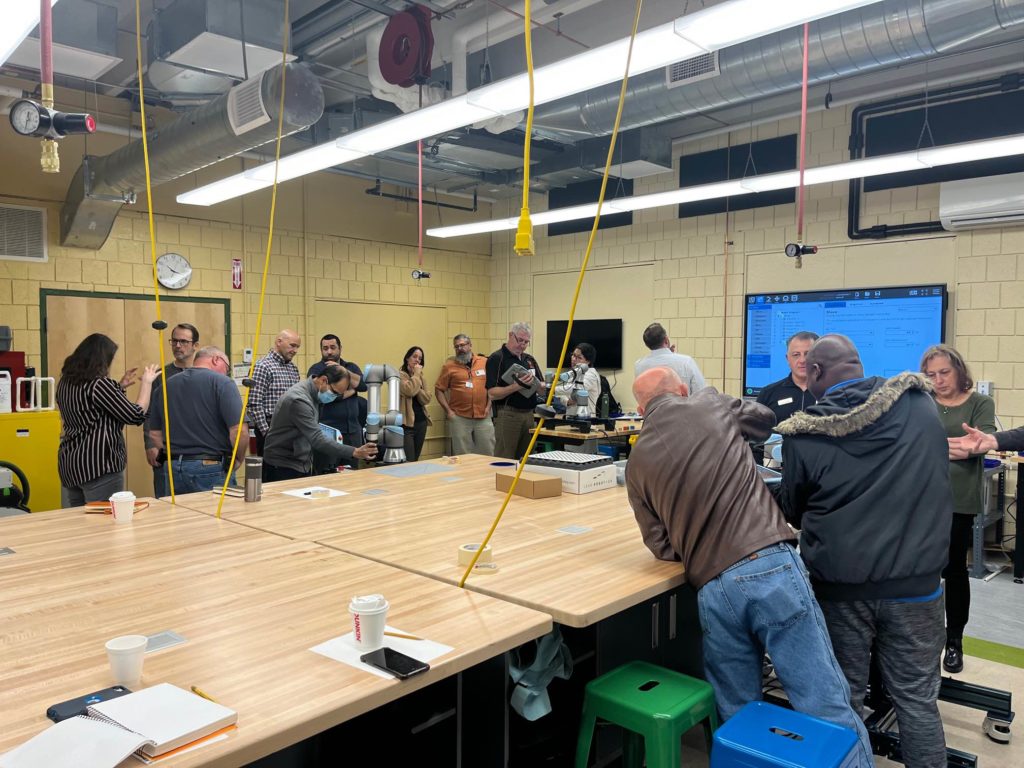 Instructors using Universal Robots at a workshop